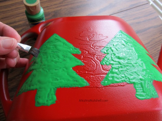 paint Christmas trees on watering can