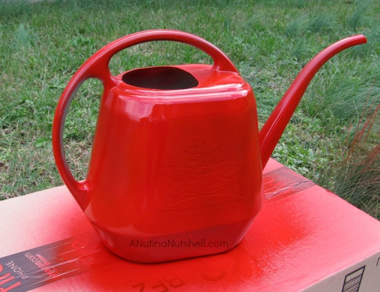 spray painting a watering can